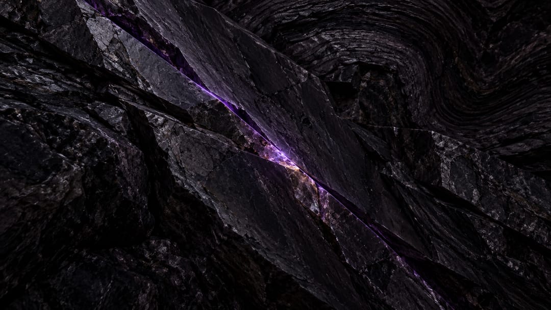 Rock under load, cleavage planes crossed by one hairline crack of light